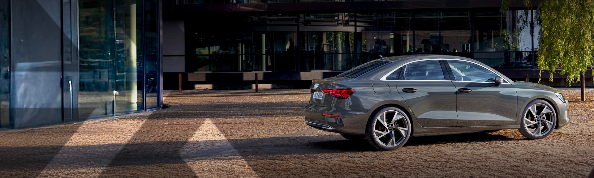 nexauto: Gray pre-owned Audi A3 in front of a modern building.