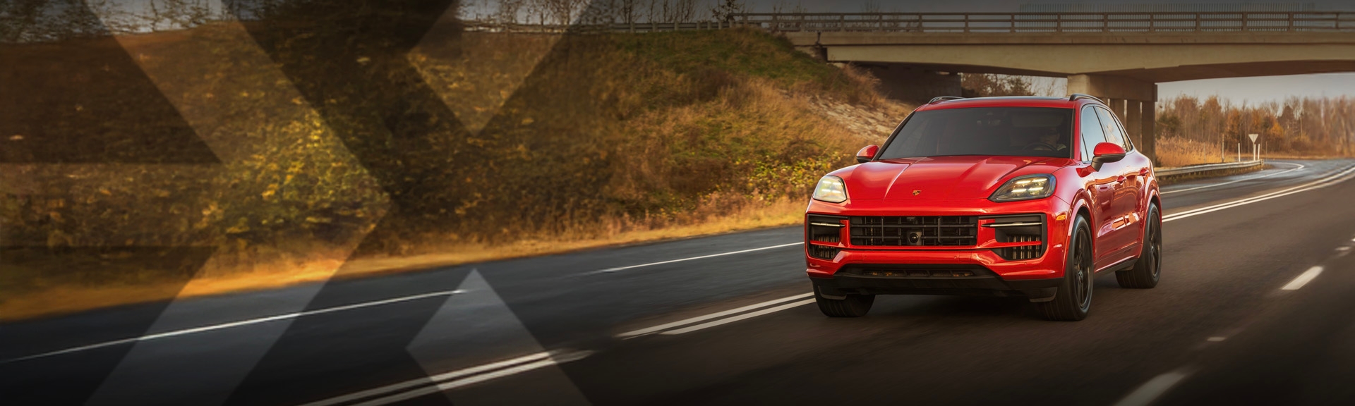 nexauto: Red pre-owned Porsche Cayenne driving on the highway.