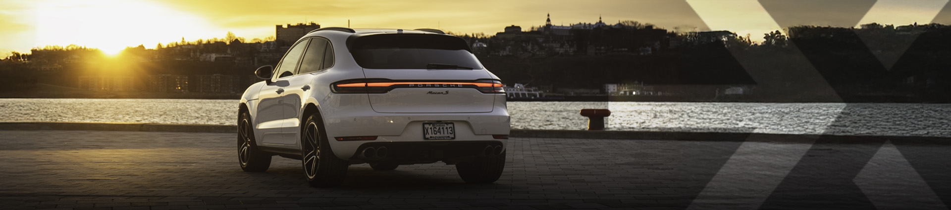 nexauto : Pre-owned white Porsche Macan S in the Quebec Old-Port, in front of the Saint-Laurence River.