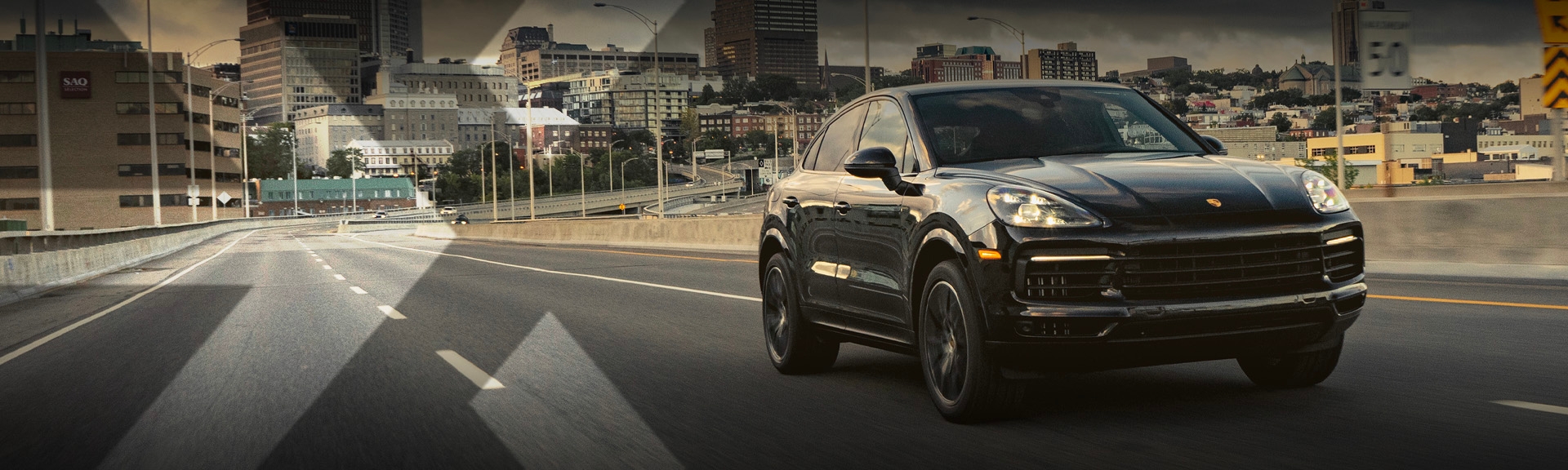 nexauto : Pre-owned black Porsche Cayenne in the snow with a forest background.
